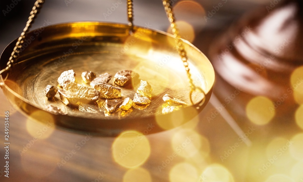 Small gold nuggets in an antique measuring