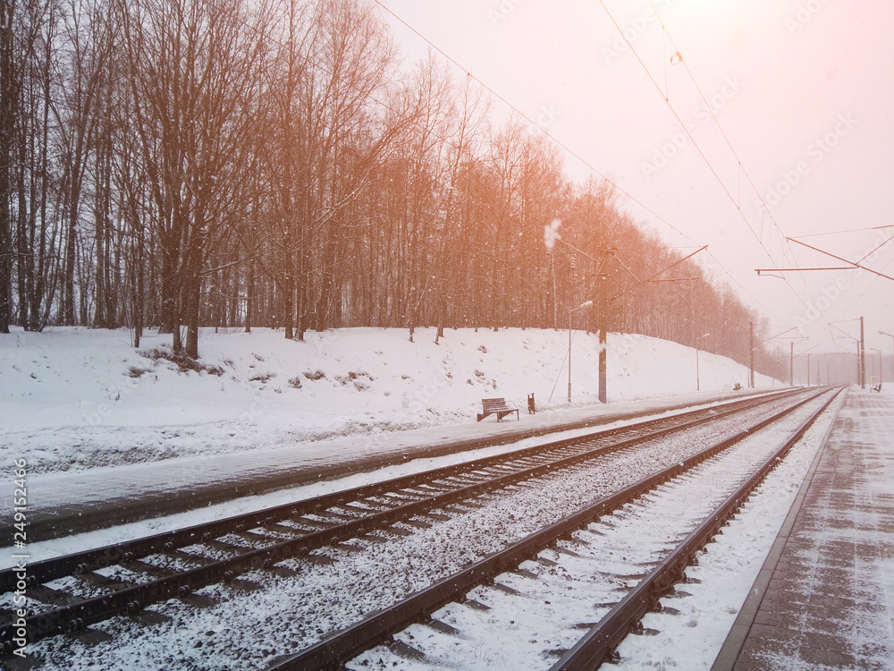 Railway in snow. Winter landscape with empty rail tracks