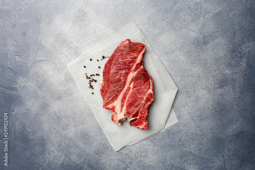 Fresh beef at baking paper on light gray background photo