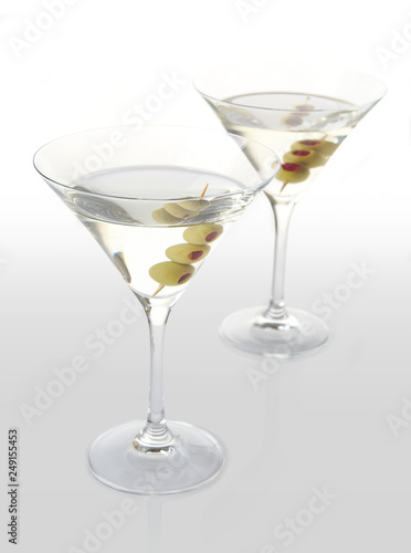 Two classic dry martini with olives on white background