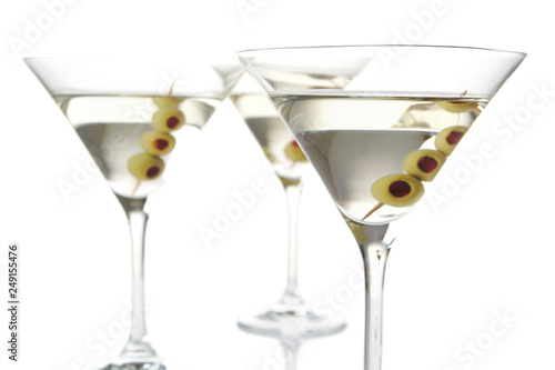 Close-up three classic dry martini with olives isolated on white