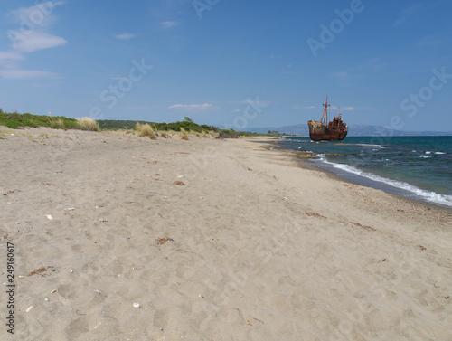 Rusty big ship shipwreck on Selinitsa beach under a deep blue sky at Gytheio Greece.