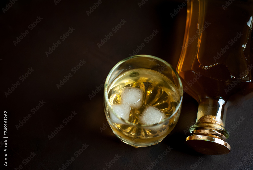 whiskey bottle and whiskey glass on concrete background,Top view with copy space for your text