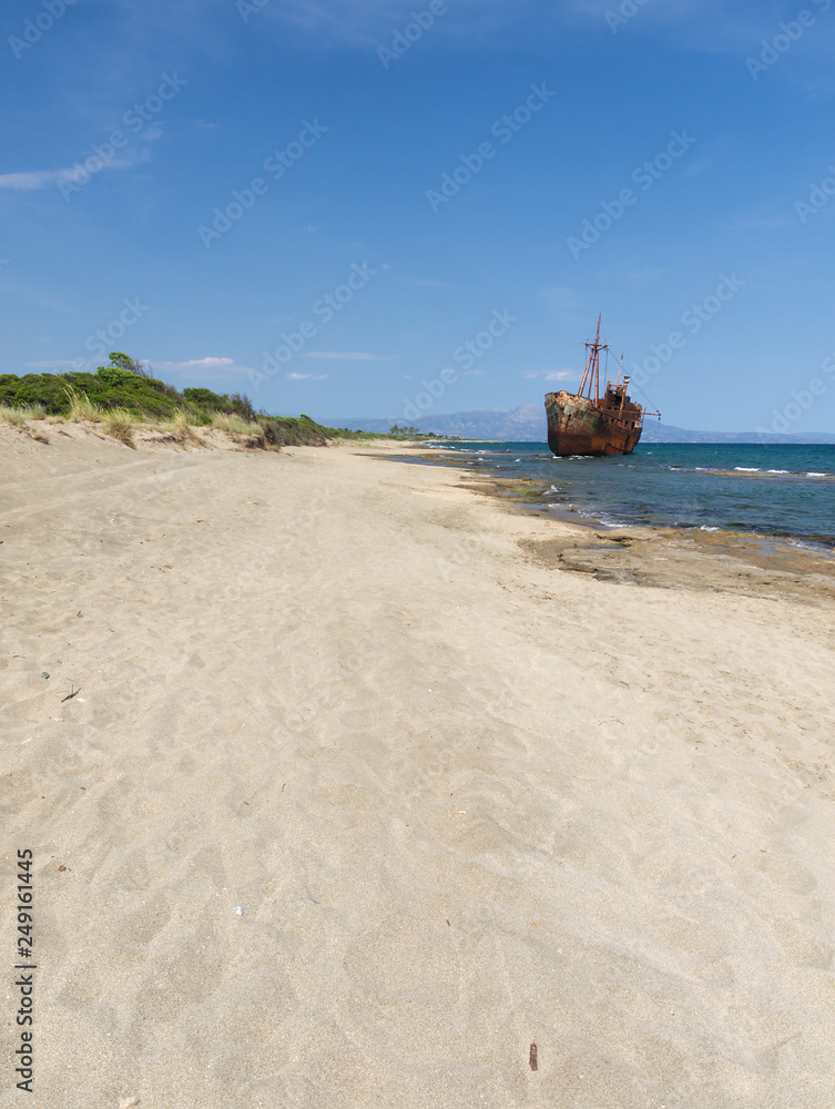 Rusty big ship shipwreck on Selinitsa beach under a deep blue sky at Gytheio Greece. Rusty big ship shipwreck on Selinitsa beach under a deep blue sky at Gytheio Greece.