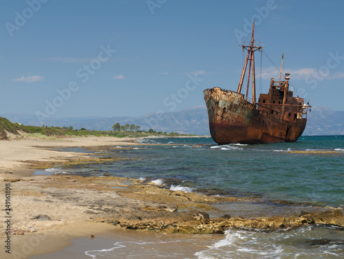 Rusty big ship shipwreck on Selinitsa beach under a deep blue sky at Gytheio Greece. © Kostas