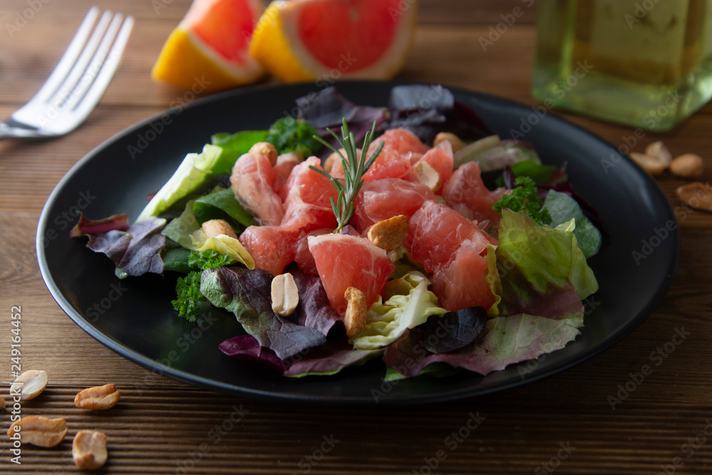 Healthy green salad with grapefruit, lose weigh food. Diet plan. Wooden rustic table.