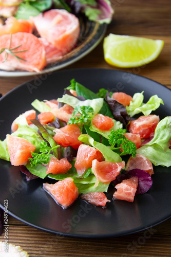 Salad with grapefruit, lose weigh food. Diet plan. Wooden rustic table.