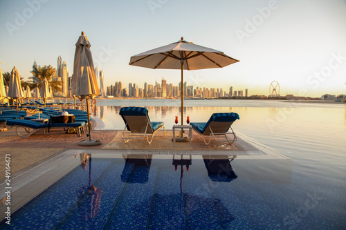 Photography Beautiful beach in Dubai with 2 sun chairs and an umbrella