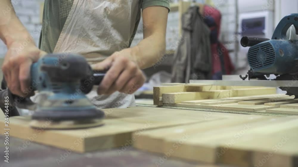 Man is craft working at a work bench with power tools Man is craft working at a work bench with power tools