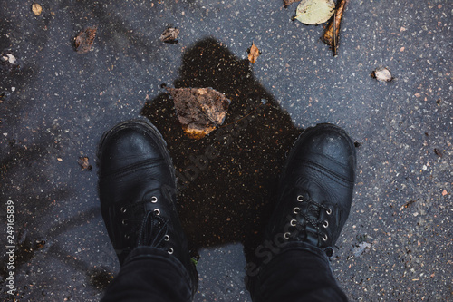 Black boots in a puddle