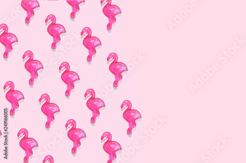 Pink Flamingo toy pattern on pastel pink background with copy space. Flamingo time for rest and relax. Creative layout summer concept for gift birthday party. Minimal style, flat lay, top view