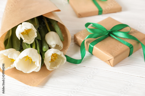 White tulips bouquet and gift box  copy space on white wooden background  spring holidays gift concept.
