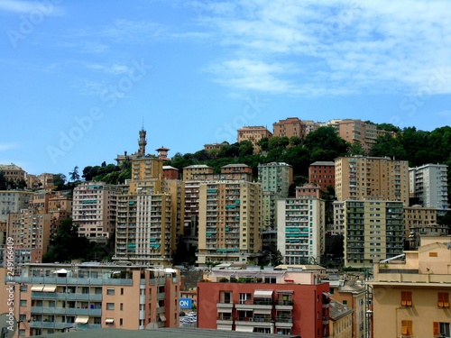 Genova, Italy - 01/24/2019: An amazing caption of the city of Genova from the hills in winter days, with a great grey sky, some natural river and beautiful buildings 