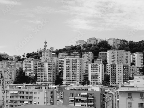 Genova, Italy - 01/24/2019: An amazing caption of the city of Genova from the hills in winter days, with a great grey sky, some natural river and beautiful buildings 