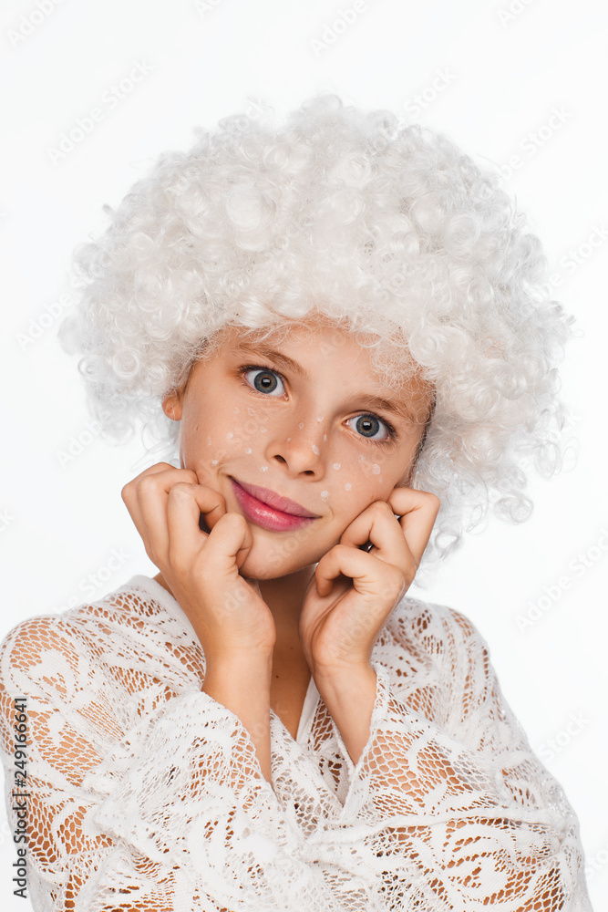 Portrait of a cheerful, energetic eight-year-old girl in a white wig and with white freckles