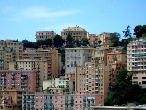 Genova, Italy - 01/24/2019: An amazing caption of the city of Genova from the hills in winter days, with a great grey sky, some natural river and beautiful buildings  © yohananegusse