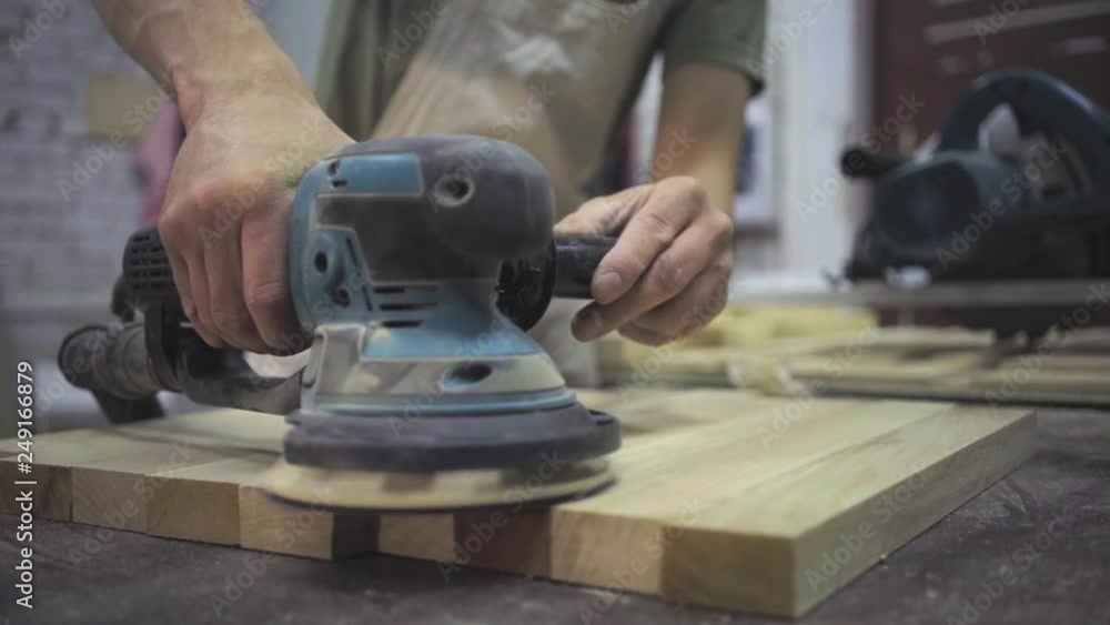 Man is craft working at a work bench with power tools Man is craft working at a work bench with power tools