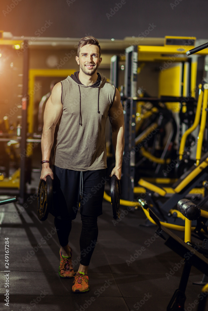 Handsome muscular man working out hard at gym Handsome muscular man working out hard at gym
