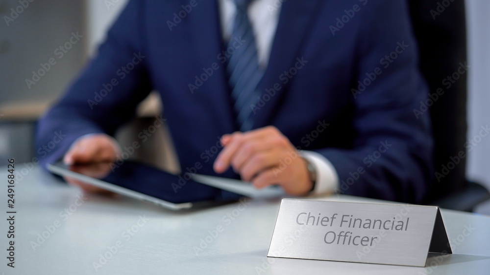 Chief financial officer of corporation using tablet pc, planning company budget Chief financial officer of corporation using tablet pc, planning company budget