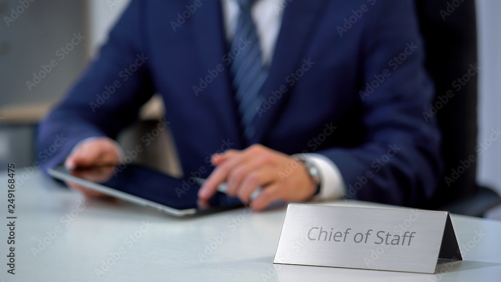 Chief of staff working on tablet pc, managing country presidents schedule Chief of staff working on tablet pc, managing country presidents schedule