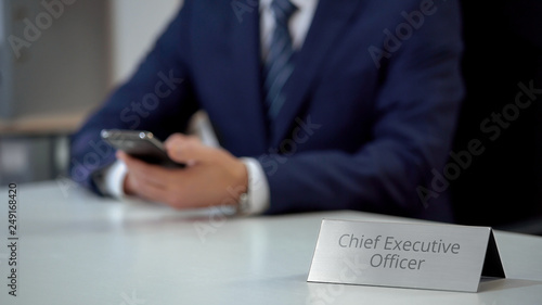 Company chief executive officer chatting with partners on smartphone, business