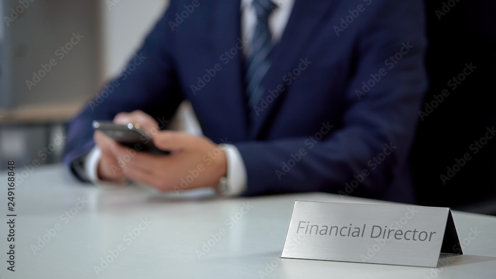 Company financial director using mobile app, typing message on smartphone Company financial director using mobile app, typing message on smartphone