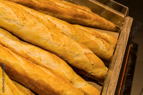 Fresh pastries from supermarket. White bread, roll, baguette. Tasty and healthy food. Texture and background.