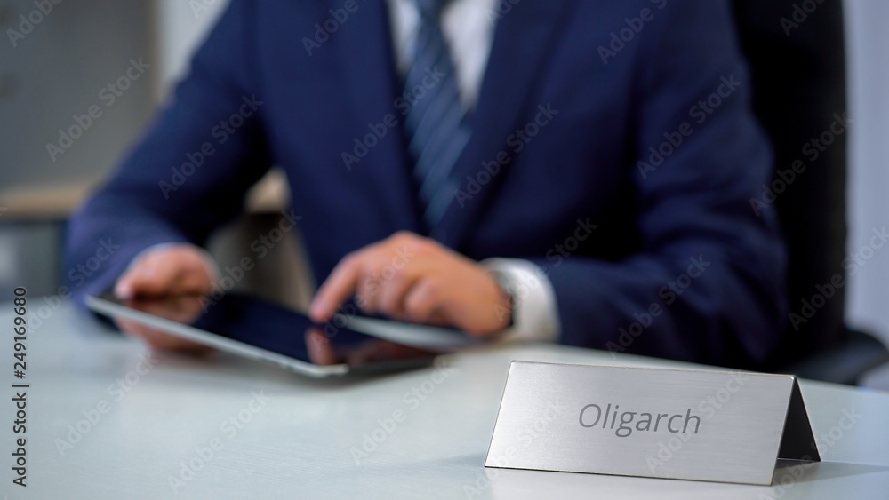 Wealthy oligarch using tablet pc, considering investment in business project Wealthy oligarch using tablet pc, considering investment in business project