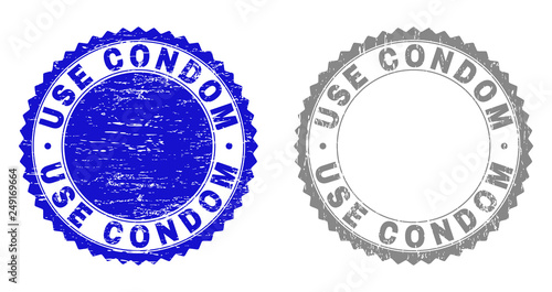 Grunge USE CONDOM stamp seals isolated on a white background. Rosette seals with distress texture in blue and grey colors. Vector rubber stamp imprint of USE CONDOM caption inside round rosette.