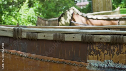 Slow motion focus shift on Native American birch bark canoes, from the front to the back. photo