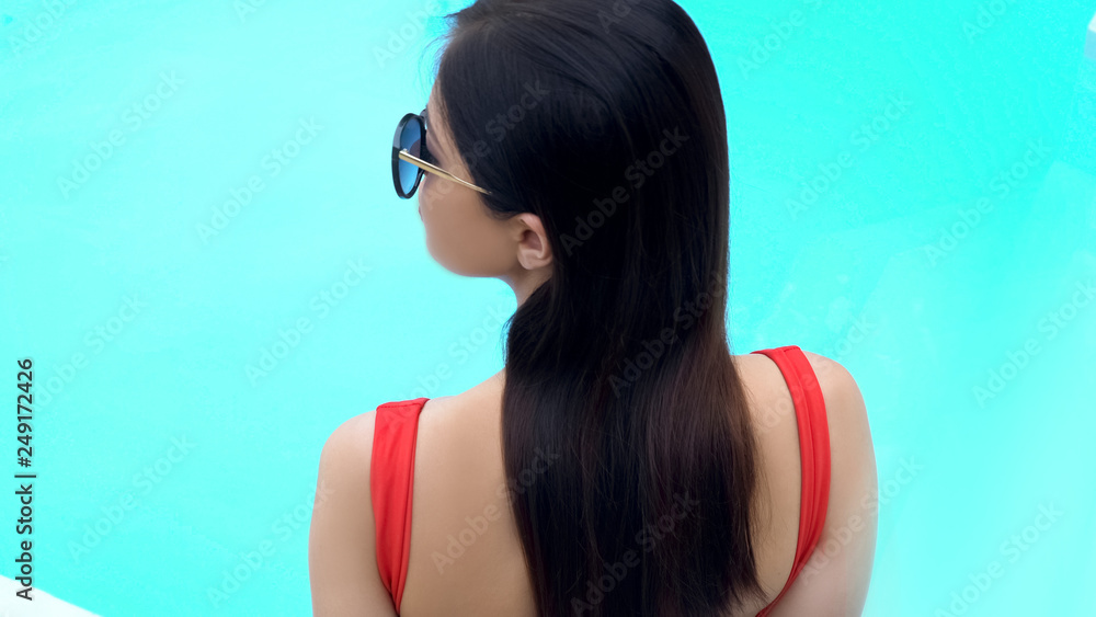Young girl with beautiful hear enjoying summer day, spa procedures, back view