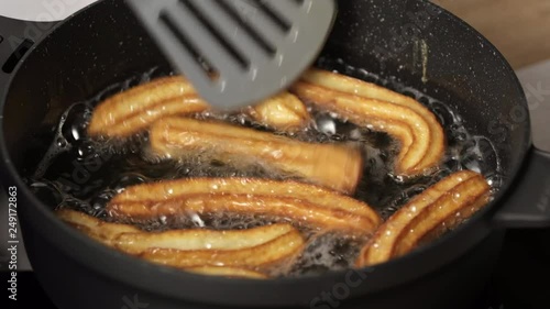 Cooking churos, dough churos in fried oil in a pan