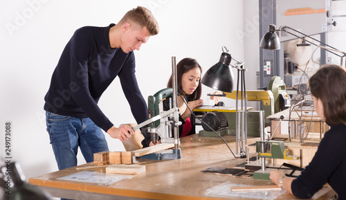 Young architects creating architectural model