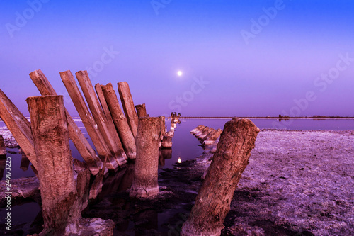 Sasyk salt lake in the moonlight at night photo