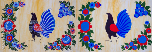 Gorodets painting with a bird and flowers, two stages of work. Russian folk Gorodets painting, which was invented in the 18th century by Russian peasants to decorate wooden objects for the house. photo