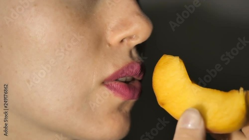 Wallpaper Mural Sexy Woman Eating fruit in slow motion. Sensual Red Lips Torontodigital.ca