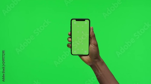 Female Hand holding Green Screen Smartphone swipe up slow 4K
