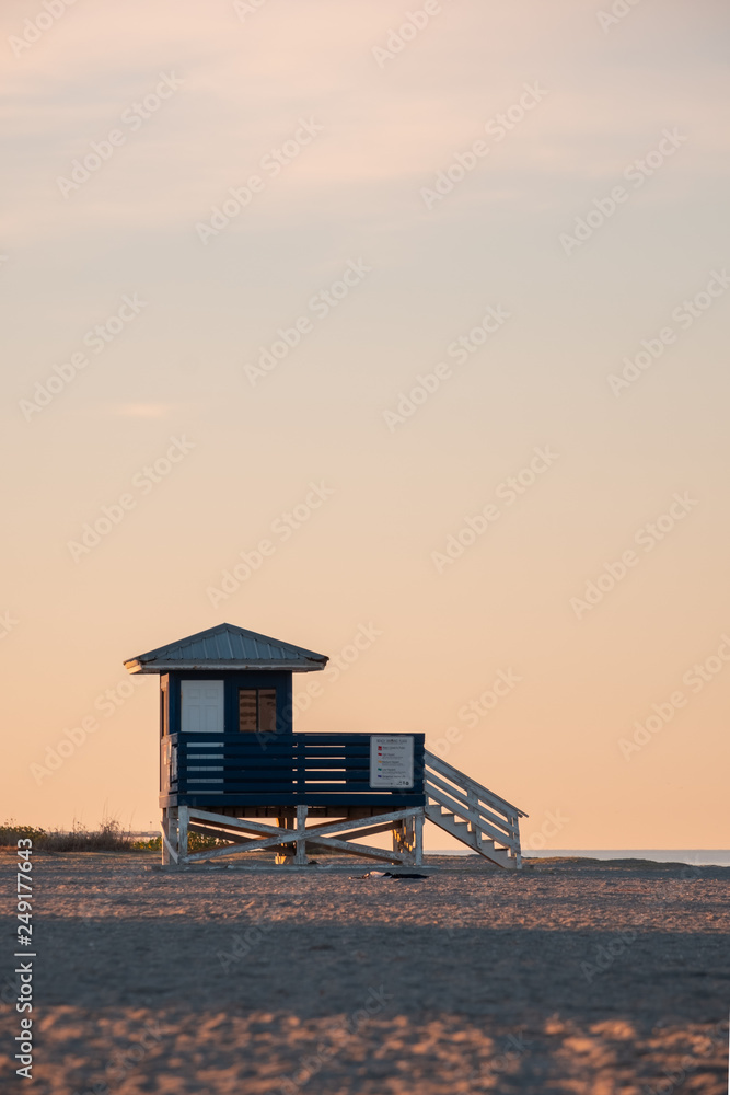 Lifeguard hut on beach at sunrise looking over gulf coast of Florida