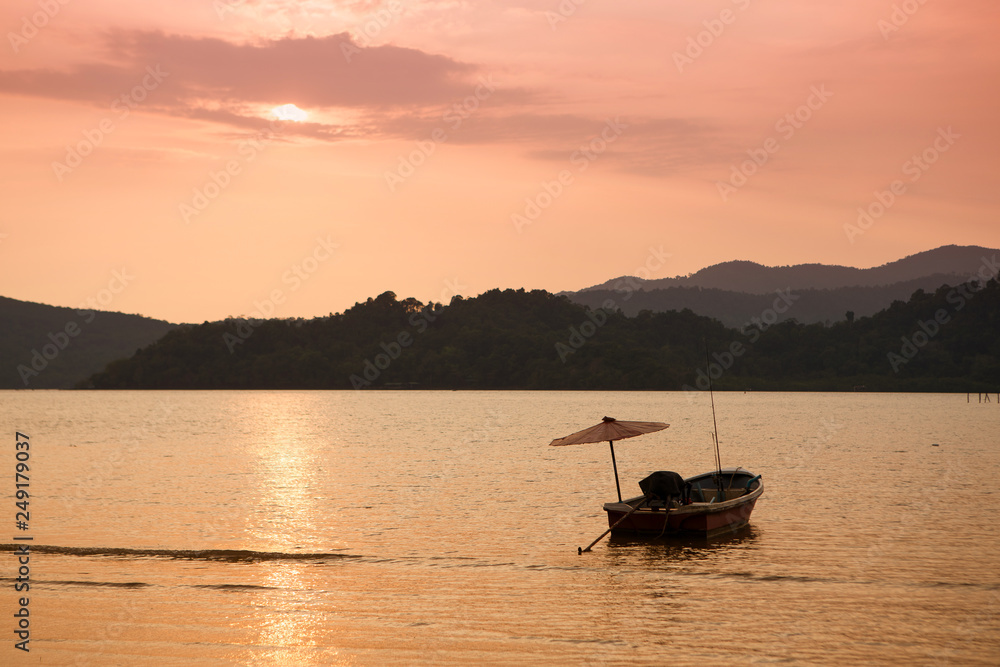 Boat at sea against mountains at sunset, tropical landscape of Thailand