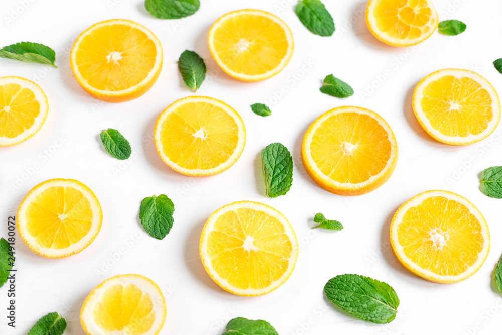 Fresh orange slices on a light background. Background with orange and mint. Beautiful photo with citrus. Vitamin C. Orange and Fresh Mint Pattern