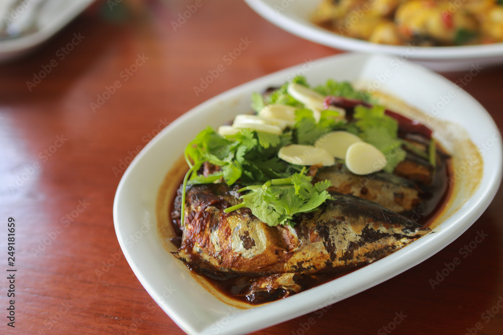 Boiled Mackerel with secrete sauce - PHATOO SATEA is Thai seafood- serve in white plate. Boiled Mackerel with secrete sauce - PHATOO SATEA is Thai seafood- serve in white plate.