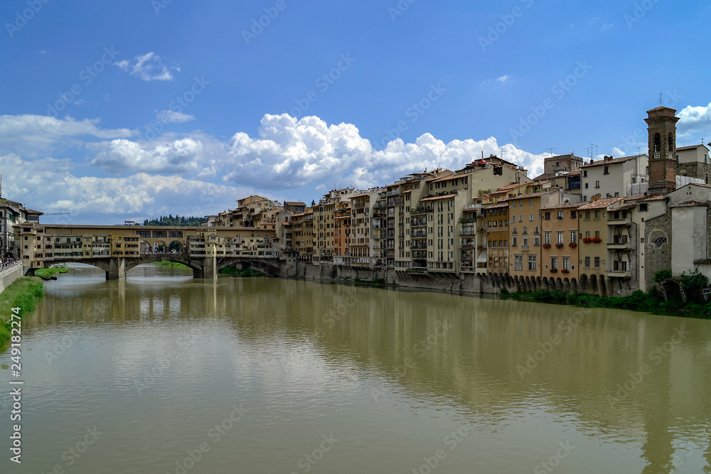 The Ponte Vecchio is a medieval stone closed-spandrel segmental arch bridge over the Arno River, in Florence, Italy, noted for still having shops built along it, as was once common.