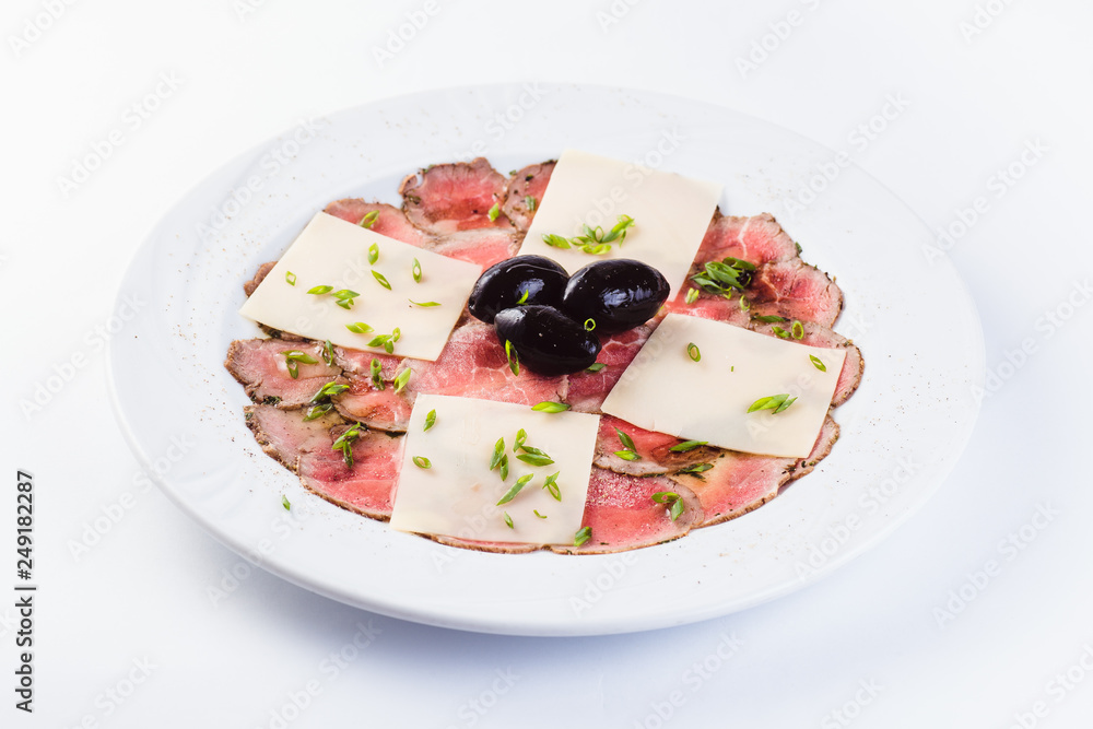 Veal carpaccio on white background close up. A traditional Italian dish.