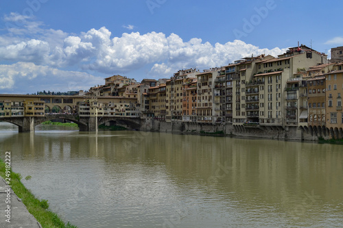 The Ponte Vecchio is a medieval stone closed-spandrel segmental arch bridge over the Arno River  in Florence  Italy  noted for still having shops built along it  as was once common.