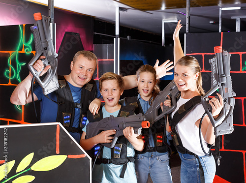 Parents and children with laser pistols
