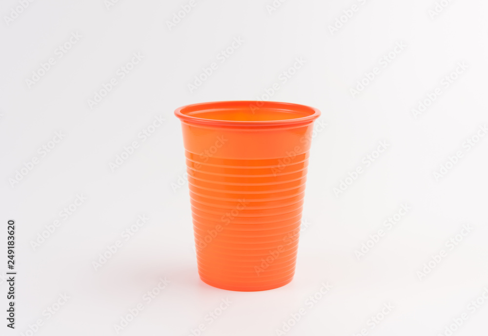 Empty orange plastic cup isolated on white Empty orange plastic cup isolated on white
