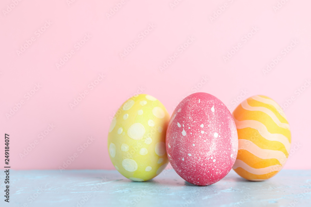 Decorated Easter eggs on color background, closeup. Space for text