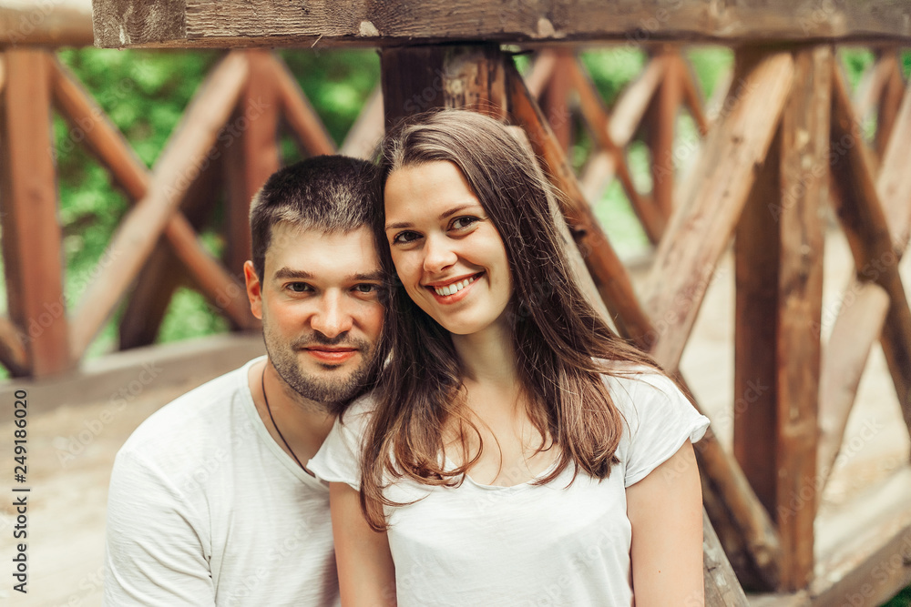 Young happy couple in summer park. Man and woman happy relathionships, young family concept. Love, youth, togetherness concept Young happy couple in summer park. Man and woman happy relathionships, young family concept. Love, youth, togetherness concept