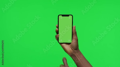 Female Hand holding Green Screen Smartphone swipe left