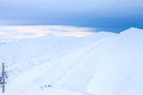 mountains in the snow on a background of clouds in the winter